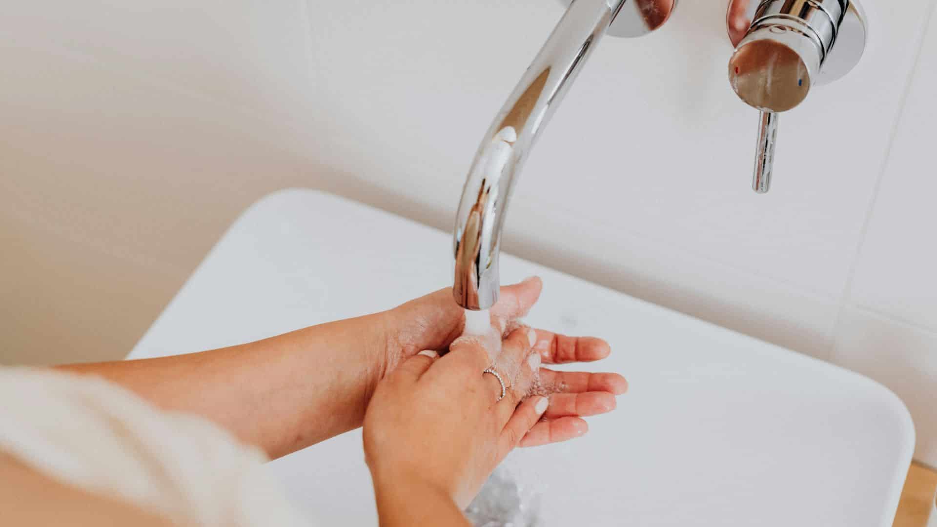 woman washing hands at a sink