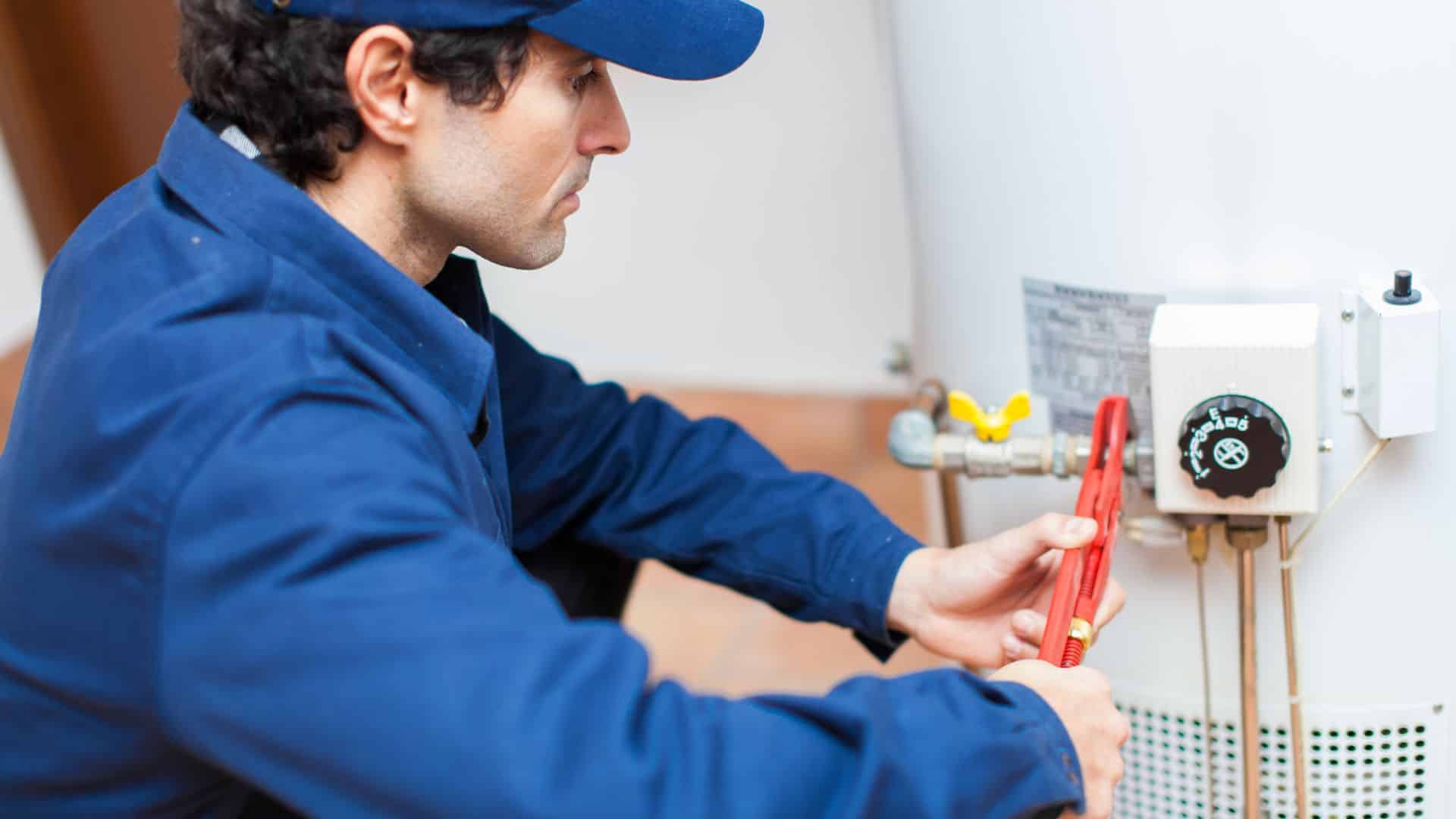 professional flushing out a water heater